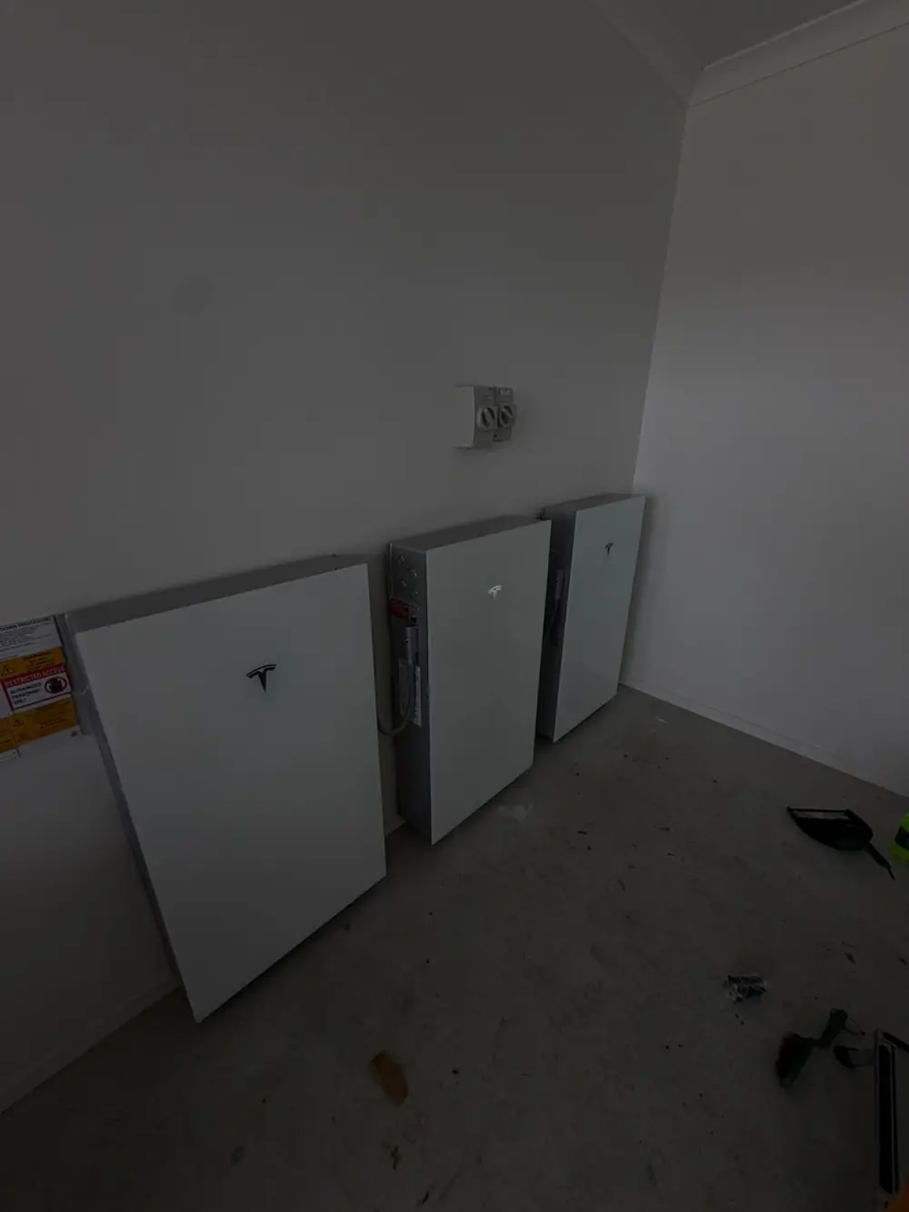 Wall-mounted batteries inside a utility room
