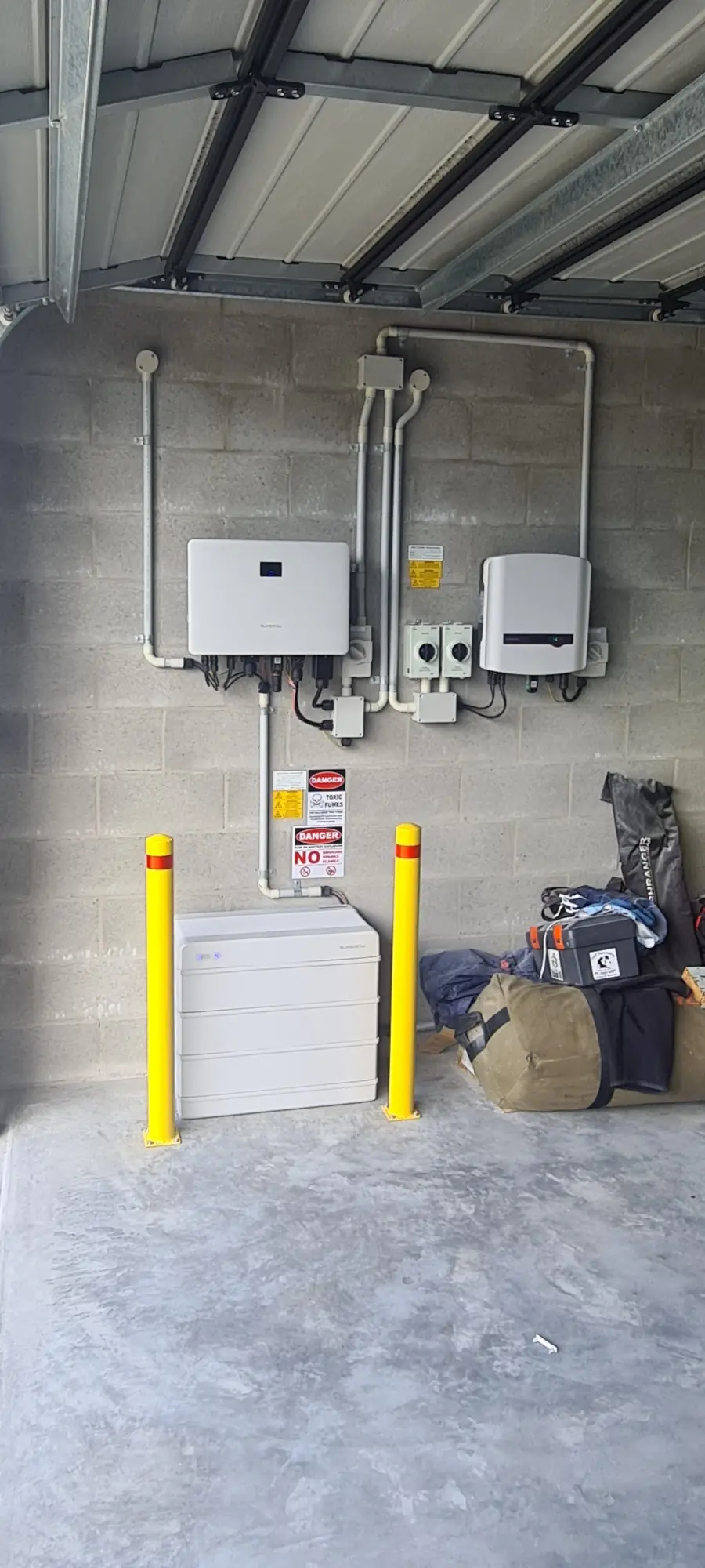Off-grid inverter and electrical gear mounted on a shed wall